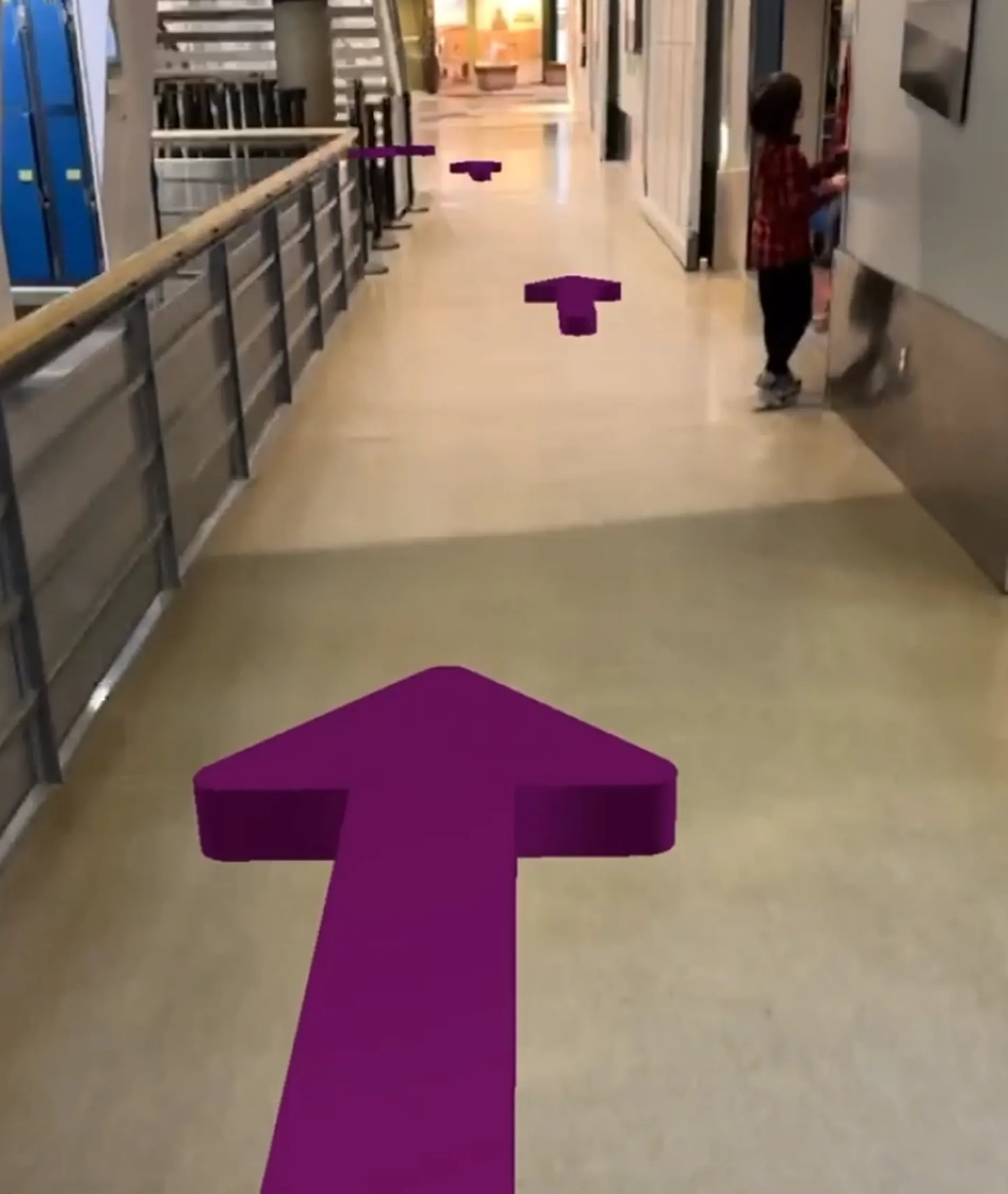 AR view overlaying arrows the exhibit hallway floor to guide visitors to the Space Gallery.