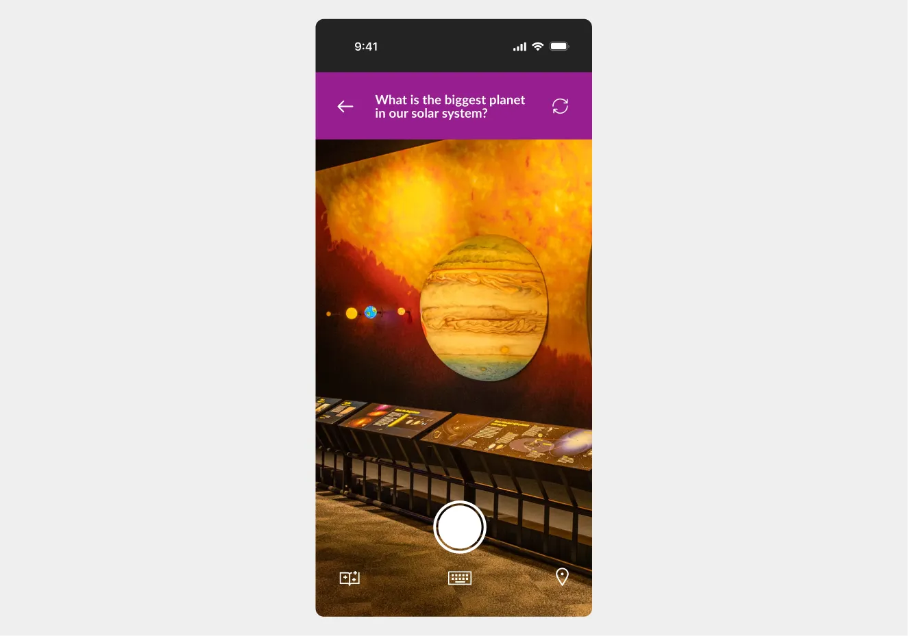 App view of a phone camera scanning an exhibit and adding a digital stamp to the user’s stamp book.”
